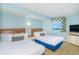 Bright bedroom featuring two beds, dresser and a window with colorful valance at 7100 N Ocean Blvd. # 1421, Myrtle Beach, SC 29572