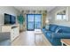 Cozy living space featuring a balcony with ocean views, bright curtains, and comfortable seating at 7100 N Ocean Blvd. # 1421, Myrtle Beach, SC 29572