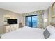 Serene bedroom with balcony access and ocean views, with neutral colors and dresser at 7100 N Ocean Blvd. # 1421, Myrtle Beach, SC 29572