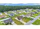 Aerial view showing a community with nicely maintained lawns, diverse homes and green, wooded areas at 716 Weston Dr., Conway, SC 29526
