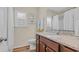 The bathroom boasts a granite countertop, wood cabinets, and bright natural light at 716 Weston Dr., Conway, SC 29526