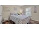Charming bedroom boasts a floral bedspread and natural light from the shuttered window at 716 Weston Dr., Conway, SC 29526