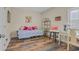 Bright bedroom showcasing wood flooring, a daybed, desk, and decorative art at 716 Weston Dr., Conway, SC 29526