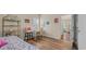 Bedroom showcasing hardwood flooring, white desk and colorful wall art at 716 Weston Dr., Conway, SC 29526