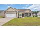 Charming single-story home with a well-maintained lawn, attached garage, and inviting front porch at 716 Weston Dr., Conway, SC 29526