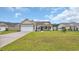 Inviting single-story residence with a well-manicured lawn, attached garage, and welcoming front porch at 716 Weston Dr., Conway, SC 29526