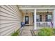 Covered front porch with seating, decorative plants, and charming curb appeal at 716 Weston Dr., Conway, SC 29526