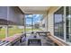 Enclosed back porch showing cushioned seating with a view of the backyard and blue skies at 716 Weston Dr., Conway, SC 29526