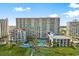 Aerial view of large building with pool, landscaping, and lounge chairs at 7200 N Ocean Blvd. # 553, Myrtle Beach, SC 29572
