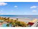 Expansive ocean view from this condo, with a glimpse of the beach, palm trees and the pool at 7200 N Ocean Blvd. # 553, Myrtle Beach, SC 29572