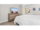 Comfortable bedroom features a TV and access to the kitchen at 7200 N Ocean Blvd. # 553, Myrtle Beach, SC 29572