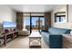 Cozy living room with TV and balcony access, perfect for relaxing at 7200 N Ocean Blvd. # 553, Myrtle Beach, SC 29572