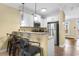 Open kitchen with granite countertop bar overlooking great room, stainless appliances, and bar stool seating at 788 Gabreski Ln. # B4, Myrtle Beach, SC 29577