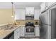 Well-equipped kitchen with stainless steel appliances, granite counters, and white cabinetry at 788 Gabreski Ln. # B4, Myrtle Beach, SC 29577
