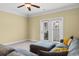 Cozy living room with plush gray sectional sofa, ceiling fan and outdoor access at 788 Gabreski Ln. # B4, Myrtle Beach, SC 29577