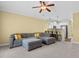 Spacious living room features an oversized couch, ceiling fan and neutral carpet at 788 Gabreski Ln. # B4, Myrtle Beach, SC 29577