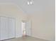 Bright bedroom with neutral tile flooring, open door, and vaulted ceilings showcases a welcoming space at 837 Sand Binder Dr., Myrtle Beach, SC 29579