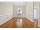 Elegant dining room with wainscoting, hardwood floors, and a chandelier under an arched window at 837 Sand Binder Dr., Myrtle Beach, SC 29579