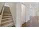 Hallway with carpeted stairs leading to the floor with hardwood at 837 Sand Binder Dr., Myrtle Beach, SC 29579