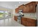 The kitchen features granite countertops, stainless steel appliances, tile flooring, and a view of the backyard at 837 Sand Binder Dr., Myrtle Beach, SC 29579