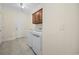 Well-lit laundry room boasts modern washer/dryer, upper cabinets, and tiled floor at 837 Sand Binder Dr., Myrtle Beach, SC 29579