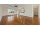 Bright living room with hardwood floors, a ceiling fan and an open floor plan flowing into the kitchen at 837 Sand Binder Dr., Myrtle Beach, SC 29579