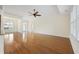 Open-concept living area featuring hardwood floors, light walls, and views of the entryway and dining space at 837 Sand Binder Dr., Myrtle Beach, SC 29579
