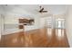 Expansive living space with hardwood floors seamlessly transitioning to a tiled kitchen and dining area at 837 Sand Binder Dr., Myrtle Beach, SC 29579