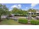 Community playground featuring swings, a slide, and benches, surrounded by trees and landscaping at 837 Sand Binder Dr., Myrtle Beach, SC 29579