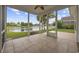 Inviting screened porch with tile flooring offering serene water views and a ceiling fan at 837 Sand Binder Dr., Myrtle Beach, SC 29579