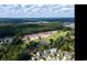 Community aerial showing golf course, ponds, and wooded areas; ideal setting near established neighborhoods at 9724 Indigo Creek Blvd., Murrells Inlet, SC 29576