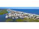 Breathtaking aerial of coastal homes and marina with beautiful blue ocean and sandy beach at 9724 Indigo Creek Blvd., Murrells Inlet, SC 29576