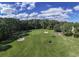 Aerial shot of a lush golf course with mature trees at 9724 Indigo Creek Blvd., Murrells Inlet, SC 29576