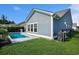Home featuring a private pool, lush lawn, and well-manicured landscaping at 981 Mourning Dove Dr., Myrtle Beach, SC 29577