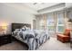Serene bedroom featuring a comfortable bed, soft lighting, and ample natural light from the windows at 981 Mourning Dove Dr., Myrtle Beach, SC 29577