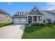 Charming home with a well-manicured lawn, two-car garage, and inviting front porch at 981 Mourning Dove Dr., Myrtle Beach, SC 29577