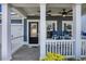 Inviting front porch features white columns, fan, and comfortable seating, perfect for enjoying the outdoors at 981 Mourning Dove Dr., Myrtle Beach, SC 29577