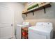 Laundry room featuring a washer, dryer, decorative shelves, and convenient storage at 981 Mourning Dove Dr., Myrtle Beach, SC 29577