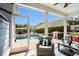 Screened porch features comfortable seating and a view of the private pool, ideal for relaxing and entertaining at 981 Mourning Dove Dr., Myrtle Beach, SC 29577