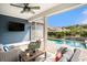 Relaxing screened porch with wicker furniture and a view of the private pool and landscaped backyard at 981 Mourning Dove Dr., Myrtle Beach, SC 29577