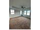 Empty bedroom features a ceiling fan, lots of natural light, and neutral carpet at 1039 Graybill Lane, North Myrtle Beach, SC 29582