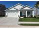Charming single-story home with a well-manicured lawn and attached two car garage at 1039 Graybill Lane, North Myrtle Beach, SC 29582