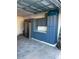 Organized garage features blue cabinets, countertop, and stainless refrigerator at 1039 Graybill Lane, North Myrtle Beach, SC 29582