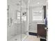 Modern bathroom featuring glass enclosed shower, elegant vanity, and window at 104 East Bay St., Georgetown, SC 29440