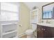 Well-lit bathroom with a window and cabinet space next to the toilet at 104 East Bay St., Georgetown, SC 29440