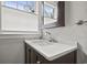 Bathroom vanity area with marble countertop, stainless steel faucet, and natural light at 104 East Bay St., Georgetown, SC 29440