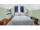 Brightly-lit bedroom features hardwood floors, a bench, and two bedside lamps at 104 East Bay St., Georgetown, SC 29440