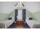 Cozy bedroom features two beds with blue accents, hardwood floors, and natural light at 104 East Bay St., Georgetown, SC 29440