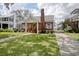 Charming brick home features a lush green lawn and classic architectural details at 104 East Bay St., Georgetown, SC 29440