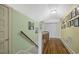 Hallway with hardwood floors and art along the walls on the upper level at 104 East Bay St., Georgetown, SC 29440